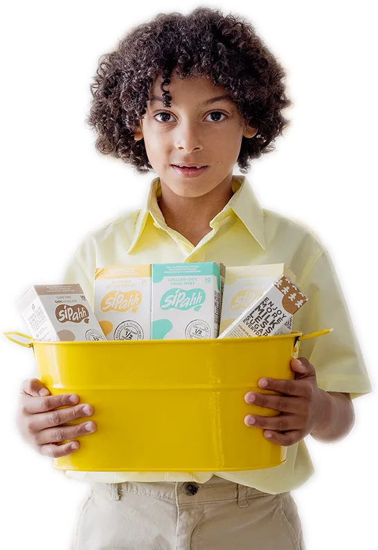 A boy holding a box of Sipahh Flavored Milk Straws